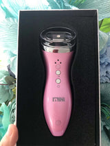 Mini Ultrasonic Scalpel in pink packaging on a floral backdrop, ideal for home beauty treatments.